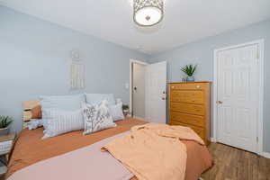 Bedroom with light wood-style floors and baseboards