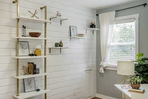 Bathroom with healthy amount of natural light and wooden walls