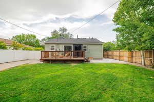 Rear view of property featuring a patio, a fenced backyard, and a wooden deck