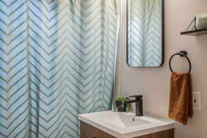 Full bathroom featuring vanity and curtained shower