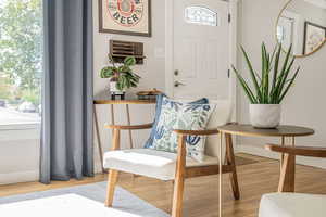 Sitting room featuring light wood-style floors and baseboards