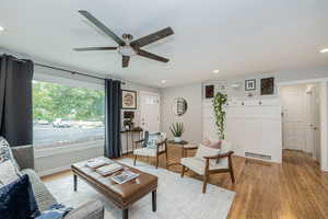 Living room with recessed lighting, light wood-style floors, and a ceiling fan