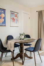 Dining space featuring light tile patterned floors