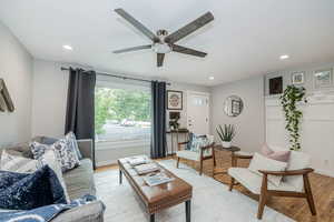 Living room with recessed lighting, light wood finished floors, and a ceiling fan