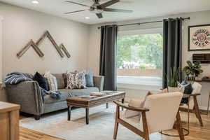 Living room with light wood-style floors, recessed lighting, and ceiling fan