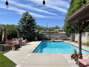 View of pool featuring a patio and a fenced backyard