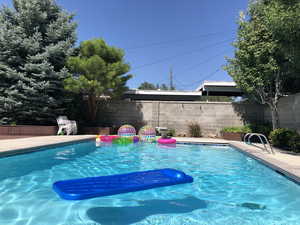 View of pool featuring a fenced backyard and a patio area