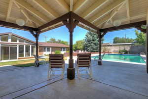Fenced backyard featuring a patio area and a sunroom