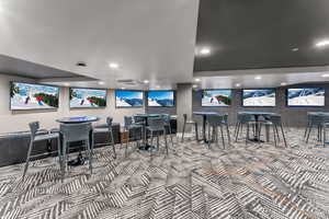 Interior space with carpet floors and recessed lighting