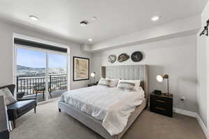 Carpeted bedroom featuring access to outside, a mountain view, a barn door, and recessed lighting