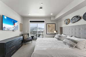Bedroom with light carpet, a mountain view, access to outside, and recessed lighting