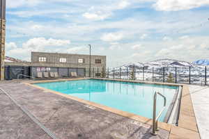 Community pool featuring a patio area and a mountain view