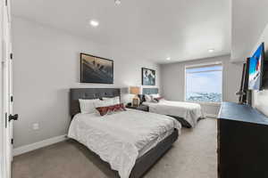 Carpeted bedroom with recessed lighting and baseboards