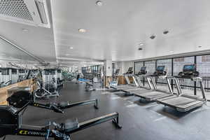 Gym featuring floor to ceiling windows and recessed lighting