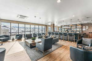 Common area featuring a wall of windows, recessed lighting, a mountain view, and brick wall