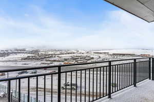 View of snow covered back of property