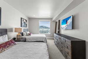 Bedroom featuring light carpet and baseboards