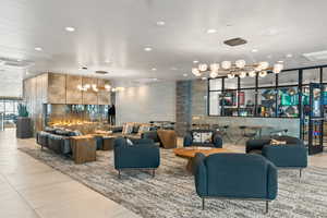 Community lobby with recessed lighting and a wall of windows