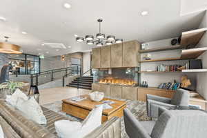 Living room featuring stairway and recessed lighting