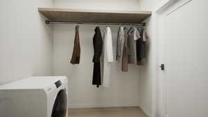 Washroom featuring washer / dryer and light wood-style flooring