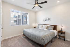 Carpeted bedroom with recessed lighting and ceiling fan