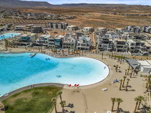 Aerial perspective of suburban area with a mountainous background and a pool area
