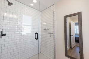 Full bath with a shower stall, recessed lighting, and ensuite bath