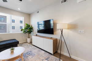 Living room with wood finished floors and recessed lighting