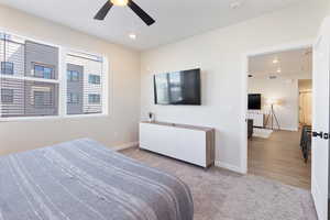 Bedroom featuring light carpet, a ceiling fan, recessed lighting, and multiple windows