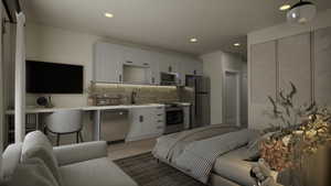 Kitchen with white cabinetry, backsplash, open floor plan, stainless steel appliances, and recessed lighting
