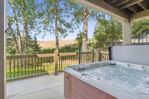 View of patio with a hot tub