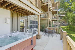 Patio / terrace featuring outdoor dining space, a hot tub, and a patio area