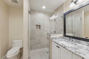 Bathroom featuring vanity, a stall shower, and recessed lighting
