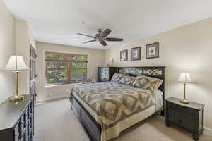 Bedroom featuring light carpet and ceiling fan