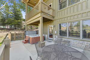 Patio / terrace featuring a hot tub, outdoor dining space, and a patio