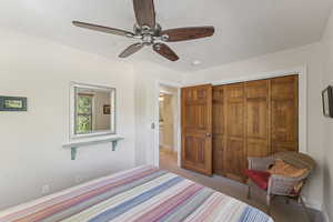 Bedroom featuring ceiling fan, a closet, and carpet