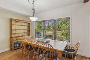 Dining space with baseboards and light wood-style flooring