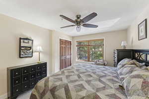 Bedroom featuring a closet, a ceiling fan, and carpet flooring