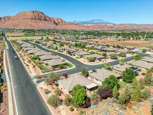 Aerial perspective of suburban area featuring a mountain backdrop and property parcel outlined