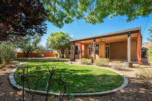 Back of property with a ceiling fan, a fenced backyard, stucco siding, and a patio