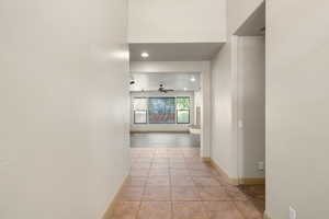 Hallway featuring baseboards and recessed lighting