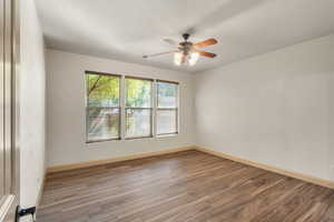 Empty room with light wood-type flooring and ceiling fan