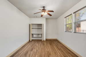 Unfurnished bedroom featuring light wood-style flooring, a ceiling fan, and a closet