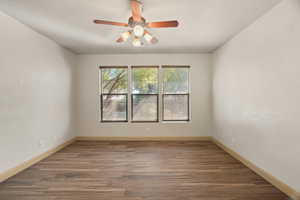 Unfurnished room with wood finished floors and ceiling fan