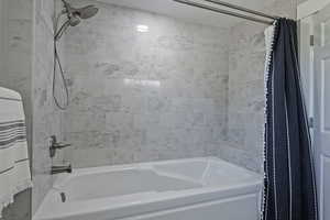 Bathroom with shower / tub combo with curtain