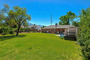 View of yard featuring an outbuilding and a patio area