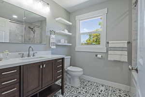 Full bath featuring vanity, a shower stall, and light tile patterned flooring