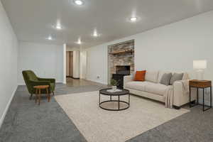 Carpeted living area featuring a fireplace and recessed lighting