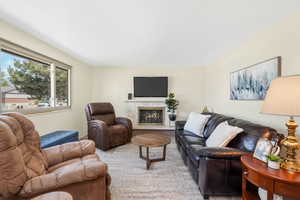 Carpeted living room featuring a fireplace