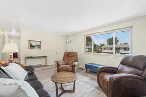 Living room featuring carpet and light off white walls